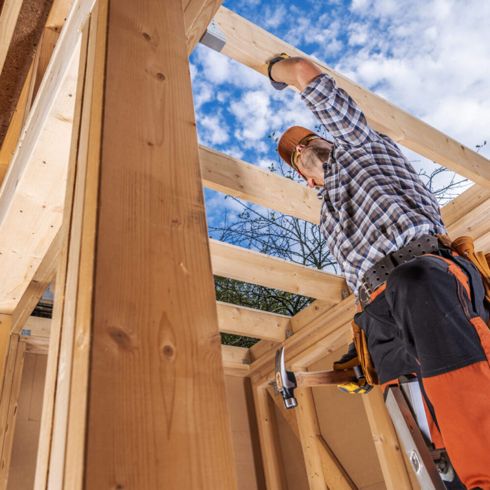 Professional Caucasian Woodwork Industry Worker in His 40s Inside Newly Built Wooden Skeleton Frame